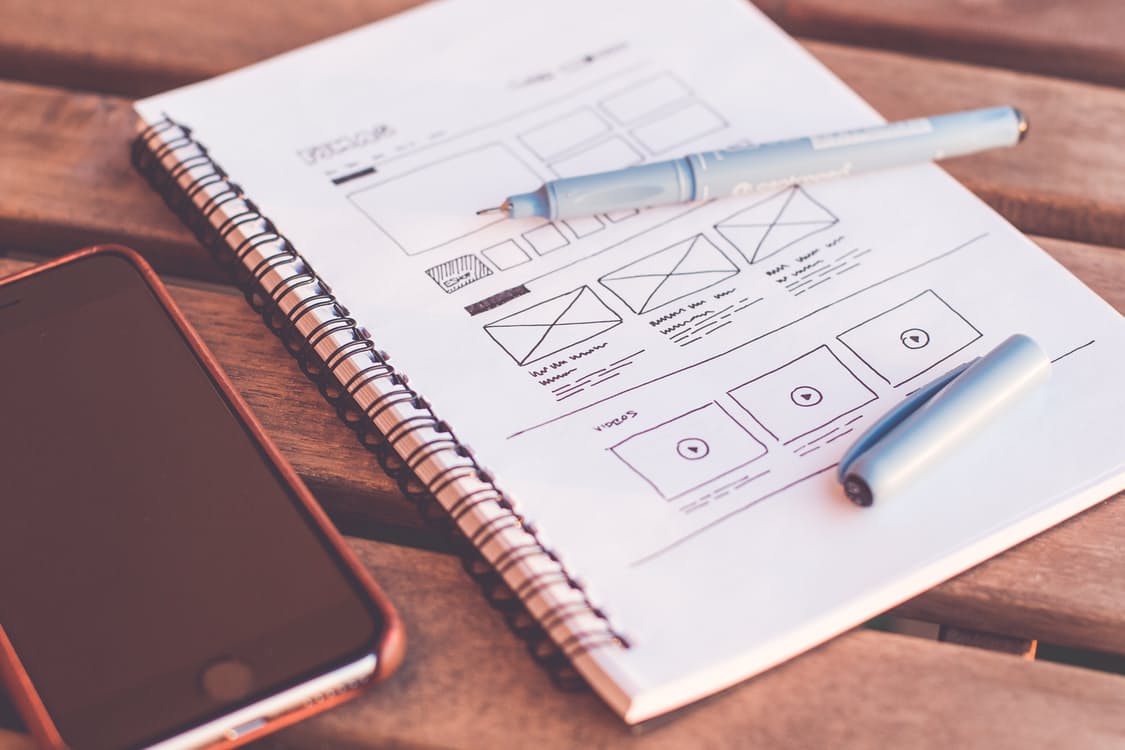 Sketching iPhone app wireframe screens.